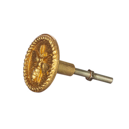 pyöreä kultainen vedin jossa mehiläisen kuva